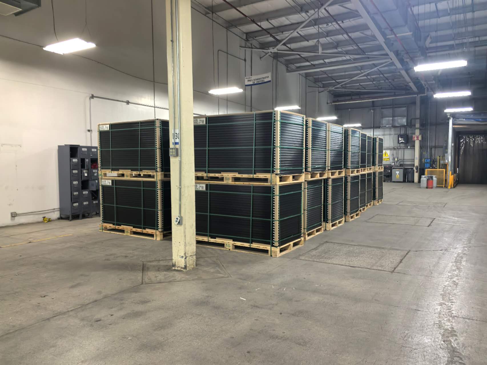 Palletized finished solar panels arranged in warehouse storage