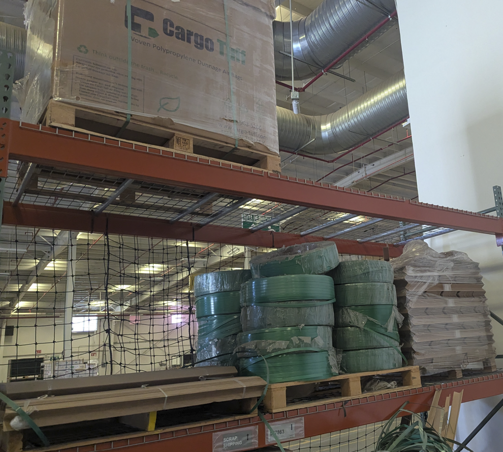 Stored spare parts, packing materials, and production supplies on warehouse shelving